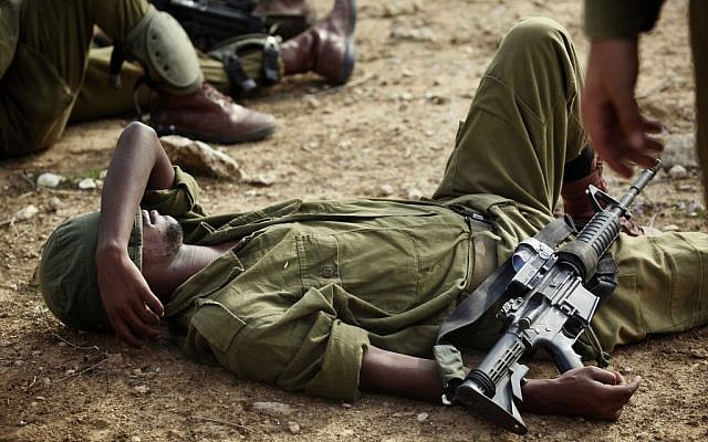 A soldier rests during training exercises on Saturday. (photo credit: Edi Israel/Flash90)
