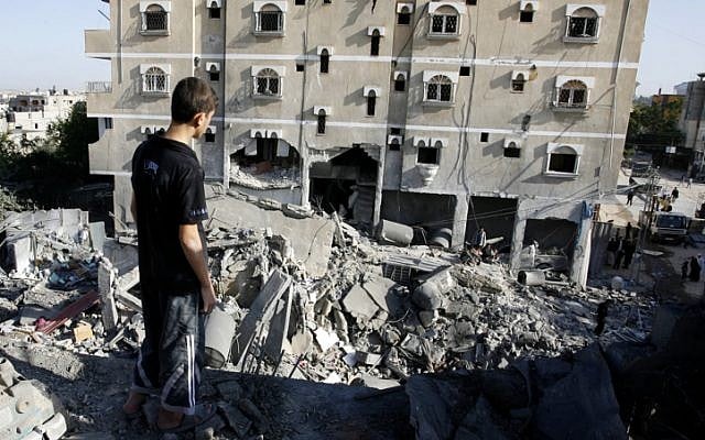A Palestinian inspects the rubble left behind after an Israeli air strikes in the Rafah refugee camp in southern Gaza on November 18 (photo credit: Abed Rahim Khatib/Flash 90)