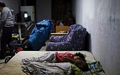 An Israeli family sleeps in a bomb shelter in the southern Israeli city of Ashkelon on Sunday (photo credit: Dima Vazinovich/Flash90)