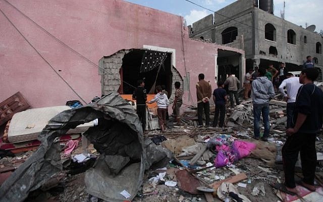Palestinians sort through the rubble of their destroyed home after an Israeli airstrike hit a Hamas official's house in the Jabaliya refugee camp in the northern Gaza Strip on November 17 (photo credit: Wissam Nassar/Flash90) Palestinians sort through the rubble of their destroyed home after an Israeli airstrike hit a Hamas official's house in the Jabaliya refugee camp in the northern Gaza Strip on November 17 (photo credit: Wissam Nassar/Flash90)