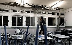 Police examine a classroom in Ashkelon damaged by rocket fire in November 2012. (photo credit: Tsafrir Abayov/Flash90)