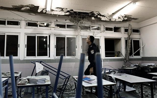 Police examine a classroom in Ashkelon damaged by rocket fire in November 2012. (photo credit: Tsafrir Abayov/Flash90) Police examine a classroom in Ashkelon damaged by rocket fire in November 2012. (photo credit: Tsafrir Abayov/Flash90)