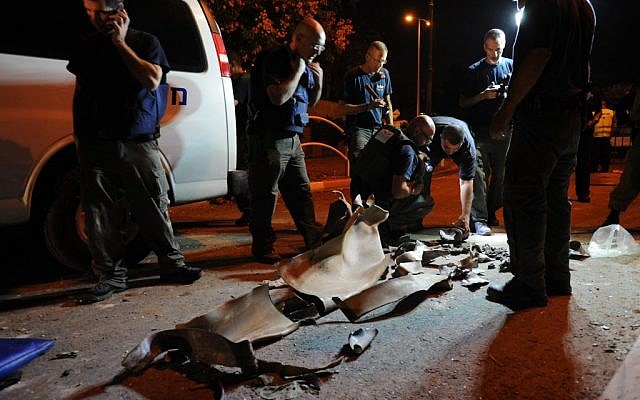 Bomb squad members inspect remains of the rocket that hit an apartment building in Rishon Lezion, near Tel Aviv, on Tuesday. (Photo by Gili Yaari/Flash90)