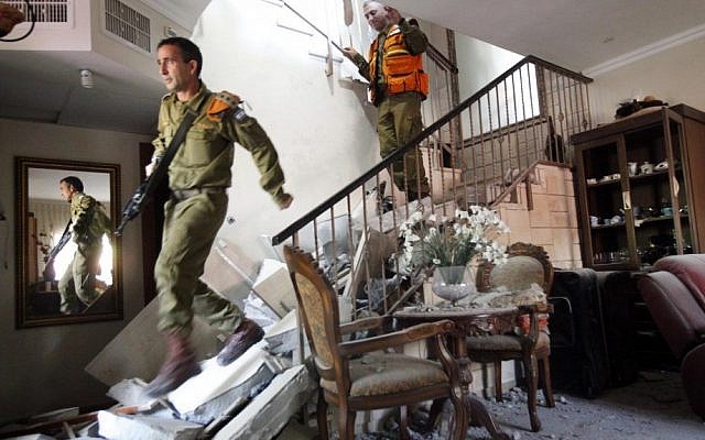 Soldiers inspecting a home hit by a missile in Beersheba Tuesday. (photo credit: Miriam Alster/Flash90) Soldiers inspecting a home hit by a missile in Beersheba Tuesday. (photo credit: Miriam Alster/Flash90)