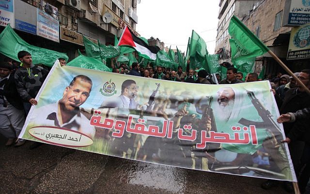 Hamas supporters rally in the West Bank city of Ramallah, on Friday, November 23 (photo credit: Issam Rimawi/Flash90)