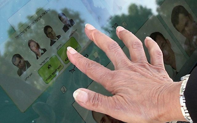 A Likud voter at a computerized voting station (photo credit: Gideon Markowitcz/Flash90)