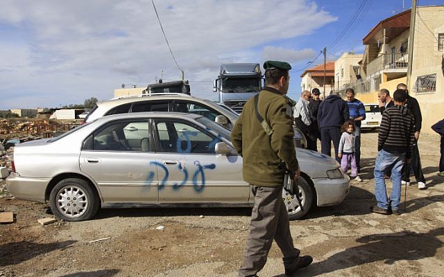 Graffiti reading "Gaza" is seen spray painted on a car outside the home of an Arab family in the East Jerusalem neighborhood of Shuafat, on November 25 (photo credit: Oren Nahshon/Flash90)