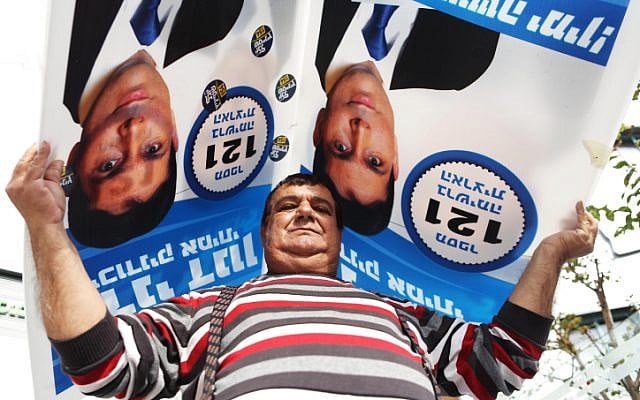A Likud supporter outside the Kfar Saba Likud polling place on Nov 26, 2012. (photo credit: Yehoshua Yosef/Flash90) A Likud supporter outside the Kfar Saba Likud polling place on Nov 26, 2012. (photo credit: Yehoshua Yosef/Flash90)