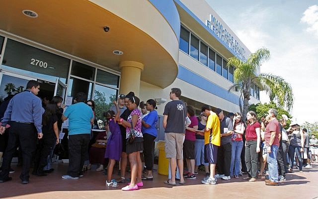 Voters stand in line to pick up their absentee ballots in Doral, Fla., Sunday, Nov. 4, (photo credit: AP/Alan Diaz) Voters stand in line to pick up their absentee ballots in Doral, Fla., Sunday, Nov. 4, (photo credit: AP/Alan Diaz)