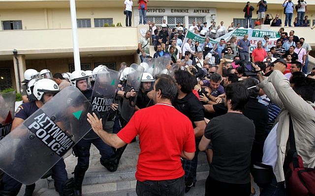 Riot police clash with protesters inside Greece's Defense Ministry in Athens on Oct. 4, 2012. (photo credit: Thanassis Stavrakis/AP) Riot police clash with protesters inside Greece's Defense Ministry in Athens on Oct. 4, 2012. (photo credit: Thanassis Stavrakis/AP)