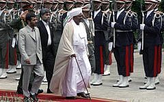 Sudanese President Omar al-Bashir, center, and Iranian President Mahmoud Ahmadinejad, left, review an honor guard, in Tehran, Iran, in 2006.  (photo credit: AP/Hasan Sarbakhshian, file)