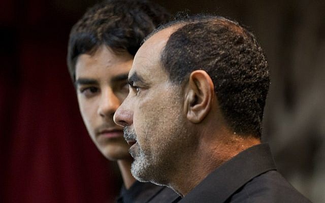 Kassim Alhimidi, right, speaks alongside his son during a memorial service for his wife, Shaima Alawadi, in March (photo credit: AP/Gregory Bull)