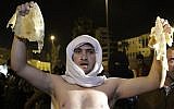 A Jordanian man holds up a piece of bread during a demonstration in Amman following an announcement that Jordan would raise fuel prices, including a 53 percent hike on cooking gas, Tuesday, Nov. 13, 2012. (photo credit: AP/Raad Adayleh)