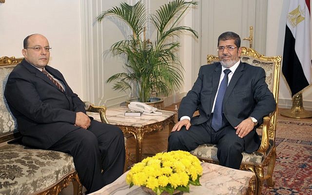 President Mohammed Morsi, right, poses for a photograph with his new Prosecutor General, Talaat Abdullah, left, in Cairo, Egypt, Thursday, Nov. 22 (photo credit: AP/Egyptian Presidency)