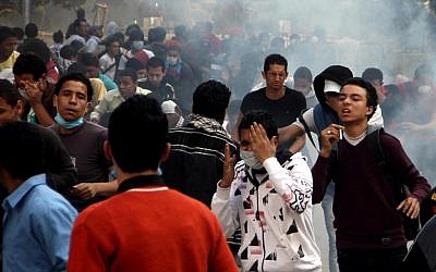 Egyptian protesters clash with security forces, not pictured, near Tahrir Square in Cairo, Egypt, Sunday, Nov. 25, 2012 (photo credit: AP/Ahmed Gomaa)