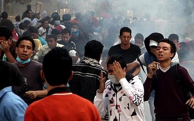 Egyptian protesters clash with security forces, not pictured, near Tahrir Square in Cairo on Sunday (photo credit: AP/Ahmed Gomaa)