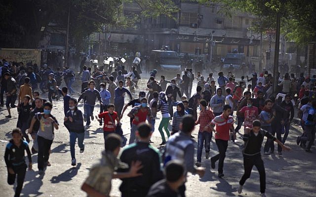 Egyptian protesters clash with security forces near Tahrir square, in Cairo, Egypt, on Wednesday, November 28, 2012 (photo credit: AP Photo/Khalil Hamra)