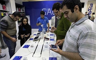 Customers try out cell phones and tablet computers in a store in Tehran, Iran, Thursday, Nov. 8, 2012 (photo credit: Vahid Salemi/AP)