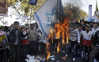 Iranians burn a representation of an Israeli flag during an annual state-backed rally outside the former US Embassy in Tehran, Iran in November 2012. (photo credit: AP)