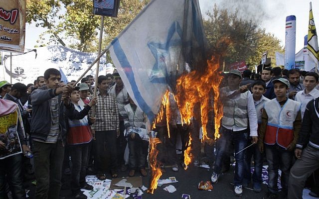 Iranians burn a representation of an Israeli flag during an annual state-backed rally outside the former US Embassy in Tehran, Iran in November 2012. (photo credit: AP) Iranians burn a representation of an Israeli flag during an annual state-backed rally outside the former US Embassy in Tehran, Iran in November 2012. (photo credit: AP)