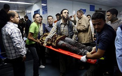 Palestinians bring a wounded man to a hospital in Gaza City, Saturday, Nov. 10 (photo credit: AP/Hatem Moussa) Palestinians bring a wounded man to a hospital in Gaza City, Saturday, Nov. 10 (photo credit: AP/Hatem Moussa)