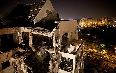 A damaged residential building in Rishon Lezion is seen after it was hit by a rocket fired by Hamas from the Gaza Strip, on Tuesday, Nov. 20, 2012. (photo credit: Oded Balilty/AP)