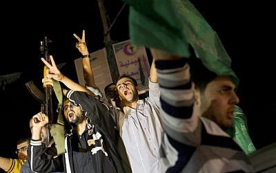 Palestinians celebrate the announcement of a cease-fire between Hamas and Israel in Gaza City, Wednesday, Nov. 21 (photo credit: AP/Bernat Armangue)