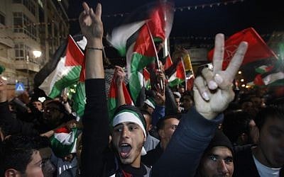 Palestinians celebrate as they watch a screen showing the UN General Assembly votes on a resolution to upgrade the status of the Palestinian Authority to a nonmember observer state, In the West Bank city of Ramallah, Thursday, November 29, 2012. (photo credit: Majdi Mohammed/AP) Palestinians celebrate as they watch a screen showing the UN General Assembly votes on a resolution to upgrade the status of the Palestinian Authority to a nonmember observer state, In the West Bank city of Ramallah, Thursday, November 29, 2012. (photo credit: Majdi Mohammed/AP)