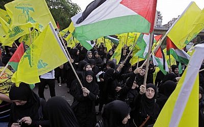 Hezbollah supporters wave Hezbollah and Palestinian flags during a demonstration against the Israeli offensive in Gaza near UN headquarters in Beirut, Lebanon, on Saturday, November 17, 2012 (photo credit: AP Photo/Bilal Hussein)