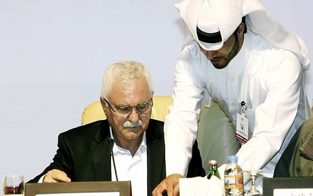 In this Nov. 11, 2012, file photo, George Sabra, the new head of the Syrian National Council, signs an agreement with the Syrian National Coalition for Opposition and Revolutionary Forces during a meeting in Doha, Qatar (photo credit: AP/Osama Faisal)