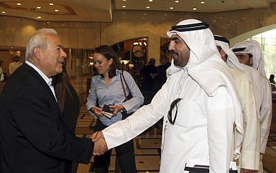 Burhan Ghalioun, leader of the opposition Syrian National Council (SNC), left, shakes hands with one of the attendees during the meeting of the General Assembly of the Syrian National Council in Doha, Qatar, Sunday, November 4, 2012 (photo credit: AP/Osama Faisal)