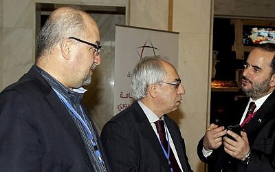 Syrian regime opponent Abdel Baset Seda, center, speaks with one of the participants during the meeting of the General Assembly of the Syrian National Council in Doha, Qatar, on Saturday, November 4, 2012 (photo credit: AP Photo/Osama Faisal)