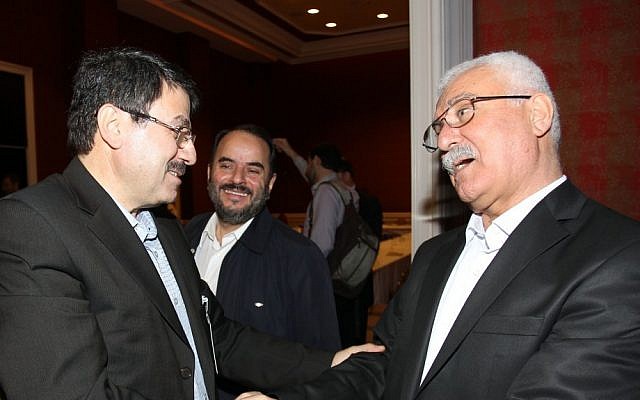George Sabra, right, is congratulated after winning the election of the Executive Office of the Syrian National Council in Doha, Qatar on Friday (AP Photo/Osama Faisal)