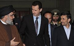 In this Thursday Feb. 25, 2010 file photo, Hezbollah leader sheik Hassan Nasrallah, left, speaks with Syrian President Bashar Assad, and Iran's then-president Mahmoud Ahmadinejad upon their arrival for a dinner in Damascus, Syria. (photo credit: AP/SANA)