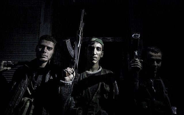 In this file photo from October 2012, Syrian rebel fighters belonging to the Liwa al-Tawhid unit pose after several days of intense clashes in Aleppo (photo credit: AP Photo/Narciso Contreras, File) In this file photo from October 2012, Syrian rebel fighters belonging to the Liwa al-Tawhid unit pose after several days of intense clashes in Aleppo (photo credit: AP Photo/Narciso Contreras, File)