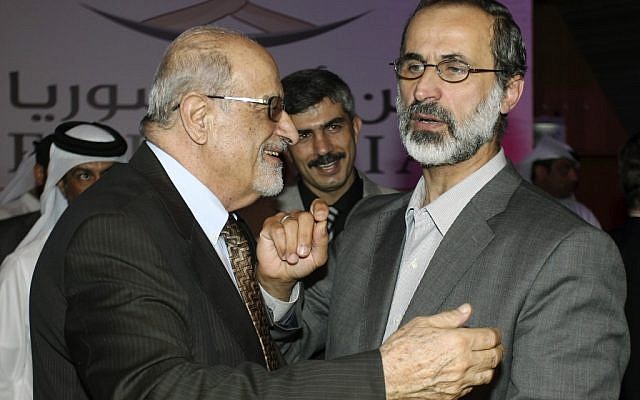 Muslim cleric Mouaz al-Khatib (right) is congratulated after being elected president of the newly formed Syrian National Coalition for Opposition and Revolutionary Forces, in Doha, Qatar, on Sunday, Nov. 11, 2012. (photo credit: Osama Faisal/AP) Muslim cleric Mouaz al-Khatib (right) is congratulated after being elected president of the newly formed Syrian National Coalition for Opposition and Revolutionary Forces, in Doha, Qatar, on Sunday, Nov. 11, 2012. (photo credit: Osama Faisal/AP)