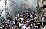 Damascus residents at the scene of a blast in the Syrian capital in November. (photo credit: AP/SANA)
