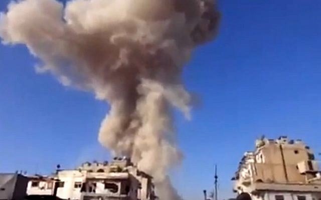 Smoke leaps the air from a building after an airstrike attack in Homs, Syria, on Wednesday, November 28, 2012. (photo credit: AP/Ugarit News) Smoke leaps the air from a building after an airstrike attack in Homs, Syria, on Wednesday, November 28, 2012. (photo credit: AP/Ugarit News)
