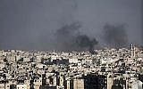Smoke rising in Aleppo, Syria after a Syrian mortar shell landed in a neighborhood. (file photo; photo credit: Narciso Contreras/AP)