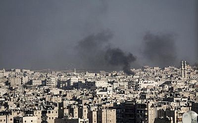 Smoke rising in Aleppo, Syria after a Syrian mortar shell landed in a neighborhood. (file photo; photo credit: Narciso Contreras/AP)