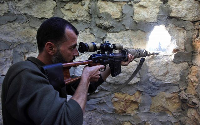 A rebel sniper aims at a Syrian army position on the outskirts of Aleppo, Syria, Wednesday, Nov. 14, 2012. (photo credit:AP Photo/Khalil Hamra)