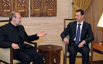 Syrian President Bashar Assad, right, meets with the speaker of the Iranian parliament, Ali Larijani, in Damascus, Syria, October 2012. (photo credit: AP/SANA)