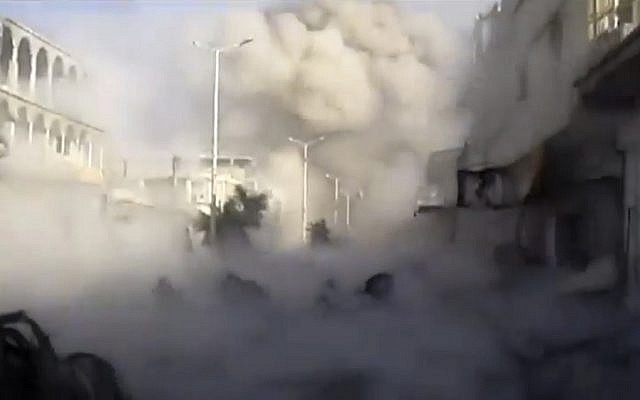 Smoke rises from the city during heavy bombing from military warplanes, in Houla, Syria, Tuesday, Nov. 6, 2012. (photo credit: Shaam News Network/AP)