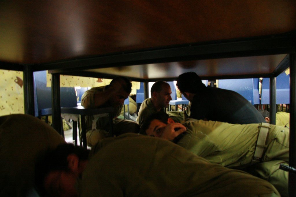 Some of the reservists take cover during a red alert siren (Photo credit: Alon)
