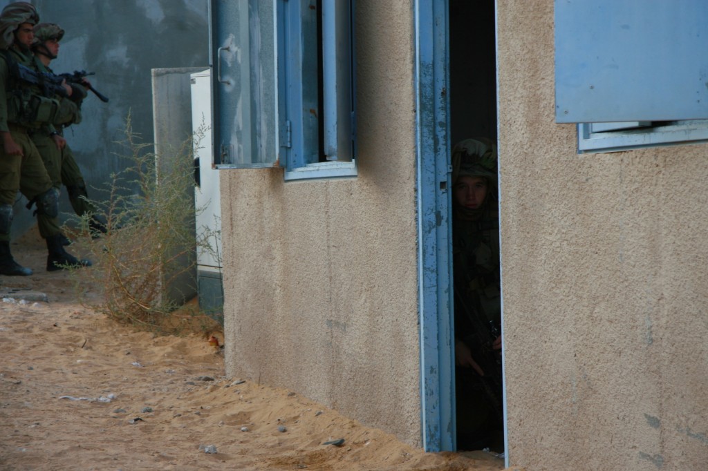 A soldier pretending to be an enemy in a mock house meant to simulate the Gaza Strip (Photo credit: Alon)