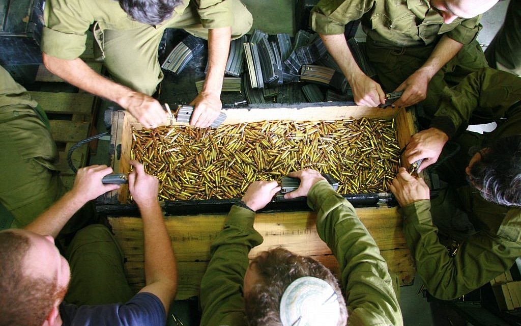 Soldiers emptying out the bullets from their magazines. (photo credit: Alon)