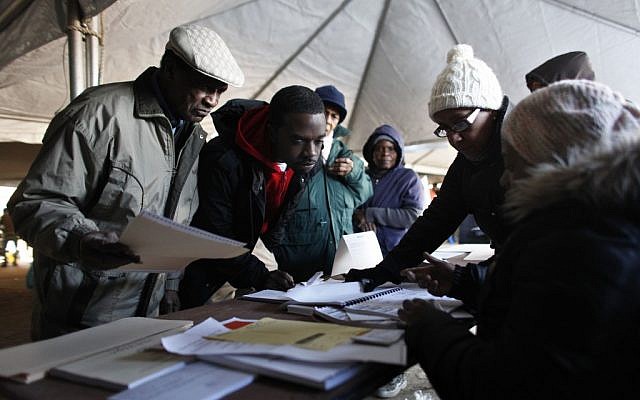 Voters check in before casting their ballots under a tent at a consolidated polling station for residents of the Rockaways on Election Day, Tuesday, Nov. 6, 2012, in the Queens borough of New York. (Photo credit: Jason DeCrow/AP) Voters check in before casting their ballots under a tent at a consolidated polling station for residents of the Rockaways on Election Day, Tuesday, Nov. 6, 2012, in the Queens borough of New York. (Photo credit: Jason DeCrow/AP)