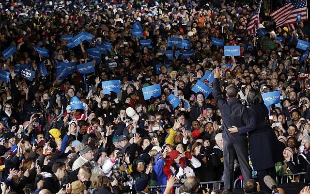 President Barack Obama and first lady Michelle Obama wave to supporters during the final 2012 campaign event in downtown Des Moines, Iowa, head of Election Day on November 6. (photo credit: AP/Pablo Martinez Monsivais)