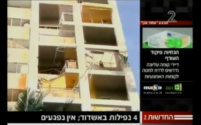 Screenshot of a building in the southern Israeli city of Ashdod that suffered a direct hit from a Gaza rocket on Saturday (photo credit: courtesy Channel 2 News) Screenshot of a building in the southern Israeli city of Ashdod that suffered a direct hit from a Gaza rocket on Saturday (photo credit: courtesy Channel 2 News)