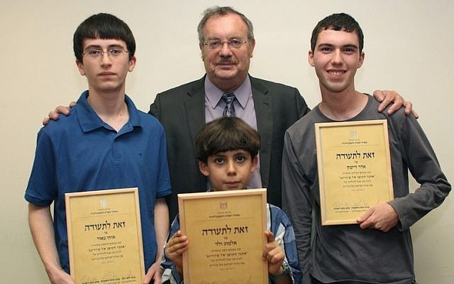 Education Minister Daniel Hershkowitz (center rear) with the winners of the Turing code contest (left to right) Itay Naor, Almog Veled, and Adar Zeitek (photo credit: Courtesy)